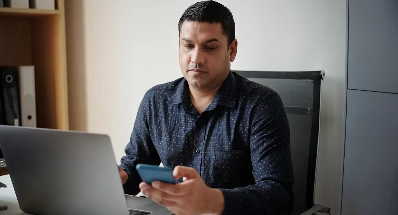 Photo of a man looking at his mobile phone